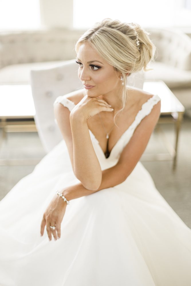bridal_morning_blonde_updo_NJ_wedding_venue_Spring_Lake_Hairstylist_Stella_Fatale Bride enjoying wedding morning dressed with blong updo