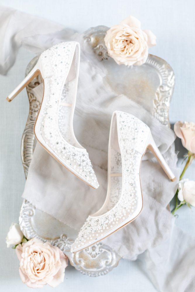bridal-shoes-luxury-wedding-flat-lay-details.jpg Beaded bridal heels styled on vintage tray with silk fabric and blush roses for elegant wedding flat lay